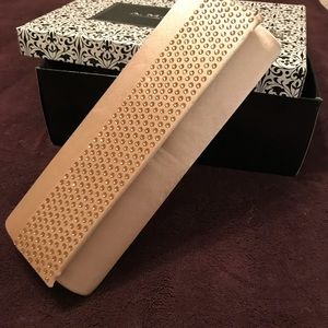 Studied champagne colored clutch